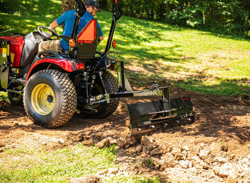 red yanmar grading scraper